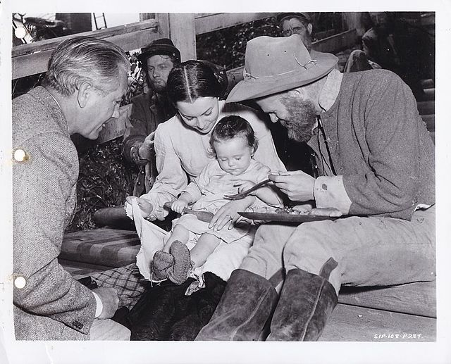 On set of Gone with the Wind (1939). Left to right: Director Victor Fleming, Olivia de Havilland, and Louis Jean Heydt