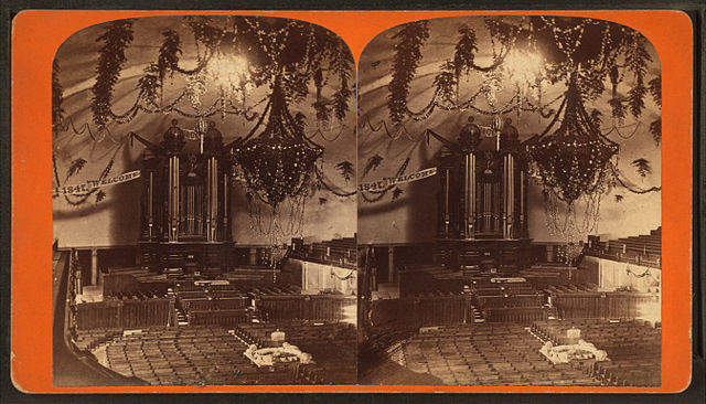 The interior of the Salt Lake Tabernacle as decorated for the Deseret Sunday School Union's July 1875 Pioneer Day celebration.