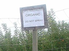 A sign outside of an organic apple orchard in Pateros, Washington, reminding orchardists not to spray pesticides on these trees Organic Apples Pateros WA cropped.jpg