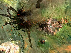 Payún Matrú při pohledu z vesmíru, černé lávové proudy podobné jazyku a oranžové sopečné kužely vedle bílé kaldery