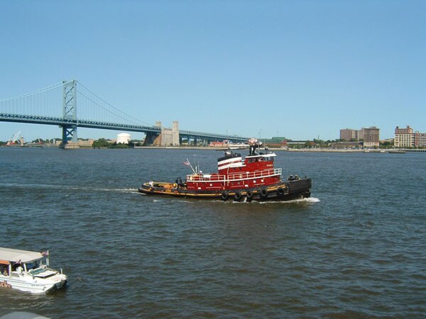 A tugboat off Penn's Landing in the Delaware River near the Benjamin Franklin Bridge in August 2007