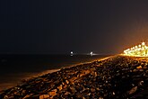 Promenade beach at night showing harbor