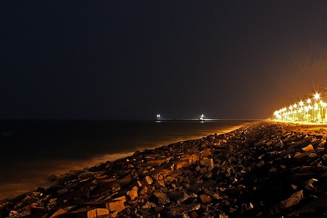 File:Rock_beach_night_harbor.jpg