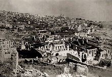 Ruins of the Armenian part of Shusha after the 1920 pogrom with the church of the Holy Mother of God "Kanach Zham" in the background Ruins of Armenian part of Shusha after 1920 pogrom 2.jpg