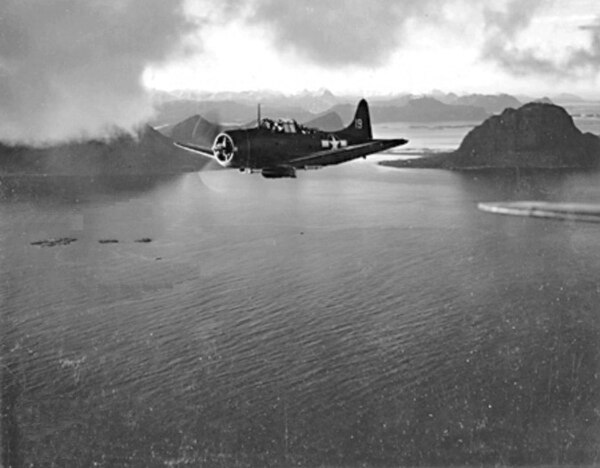 A US Navy Dauntless dive bomber flying near the Norwegian coast during Operation Leader