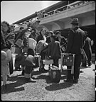 A family arrives at the Tanforan grandstand. Dorothea Lange, 1942.