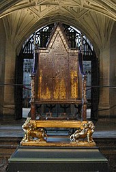 King Edward's Chair in Westminster Abbey. A 13th-century wooden throne on which the British monarch sits when he or she is crowned at the coronation, swearing to uphold the law and the church. The monarchy is apolitical and impartial, with a largely symbolic role as head of state. SanktEdvardsstol westminster.jpg