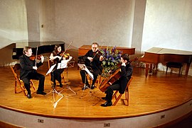 A string quartet in performance. From left to right – violin 1, violin 2, viola, cello