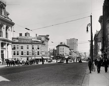 Looking north towards the corner of Genesee and Bleecker streets, c. 1900-1915. Streetcars can be seen crossing a bridge over the Erie Canal. The Busy Corner.tif