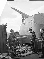 Sailors aboard HMS Glasgow clear cartridge cases ejected from the twin 4 inch Mark XVI guns The Royal Navy during the Second World War HMS Glasgow 4-inch AA gun crew A 21143.jpg
