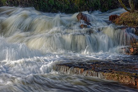The rapids of Borgviksälven running through the old iron works in Borgvik, Sweden.