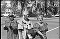 Three African American women singing and walking in a street in the Capitol Hill neighborhood, the day of the Million Man March in Washington, D.C..jpg