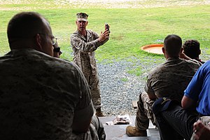 U.S. Marine Gunner Christian P. Wade, platoon commander of Training and Education Command, shows members of the Marine Corps Executive Forum (MCEF) how to load an ammunition magazine in Quantico, Va, during 110708-M-KS211-217.jpg
