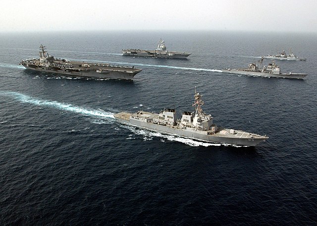 French aircraft carrier Charles de Gaulle (rear), and US Navy carrier USS Ronald Reagan conducting joint operations in the Persian Gulf; both with the