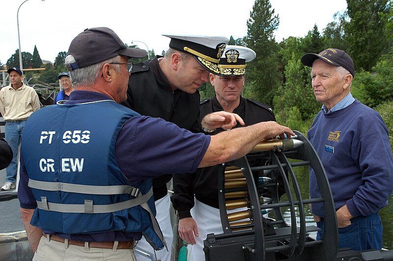 File:US Navy 060608-N-8797R-001 Bob Alton, a volunteer with the "Save PT Boat 658 Association," points out the particulars of the 37mm automatic cannon to Rear Adm. William French, commander, Navy Region Northwest.jpg