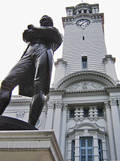 Statue of Stamford Raffles in front of the clock tower Victoria hall.jpg