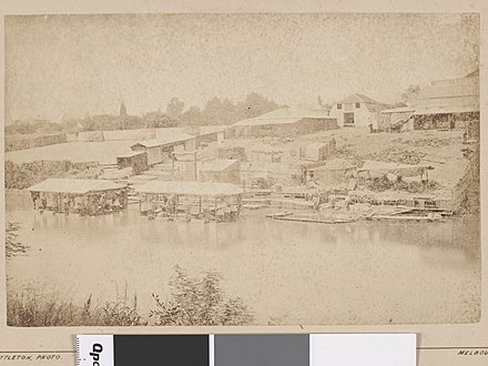Photograph of wool washing sheds in and on banks of Yarra River in late 19th century