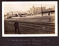 "A roam around Parsons City (en route for Texas)" Railway tracks in a city, with a car and horse and cart in the background. (3549696624).jpg