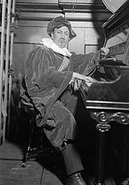 A man in costume sitting at a piano.