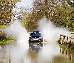 Flooding on the road to Nether Heyford from Upper Heyford Northamptonshire in April. 2012 flooding in Nether Heyford.jpg