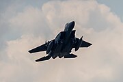 An F-15E Strike Eagle, tail number 97-0218, taking off from RAF Lakenheath in England. The aircraft is assigned to the 492nd Fighter Squadron.