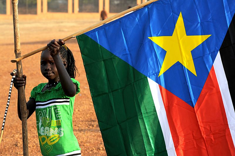 File:A young girl hangs the South Sudan flag (5925619011).jpg