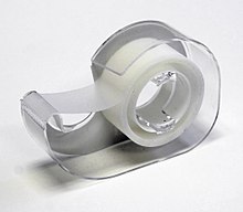 A roll of adhesive tape in a dispenser Adhesive tapes clear.JPG