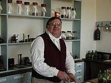 A museum interpreter explains aspects of a 19th-century apothecary in Old Salem Apothecary.JPG