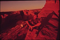 BACKPACKERS TERRY MCGAW AND GLEN DENNY REST IN THE SETTING SUN AT THE END OF THE TRAIL TO DELICATE ARCH - NARA - 545770.jpg