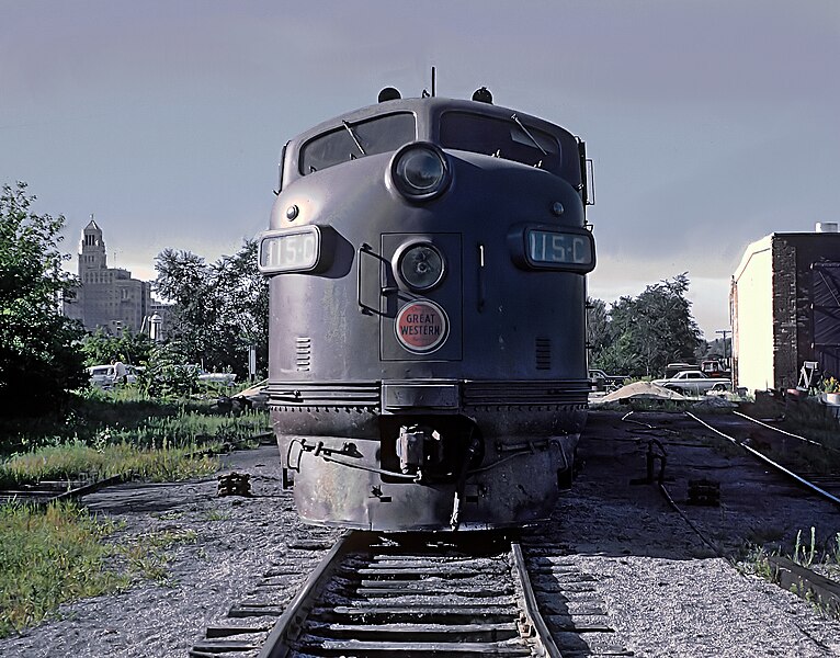 File:CGW 115-C (F5A) on ready track in yard at Rochester, MN. Roundhouse is at extreme right and the main building of the Mayo Clinic can be seen the left. August 7, 1962 (22428536722).jpg