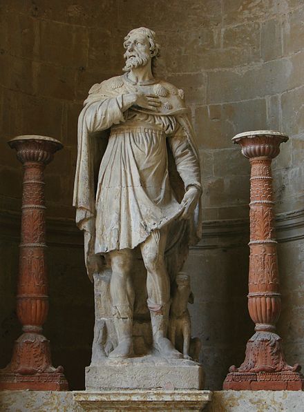 Statue of Saint Roch in Auch cathedral. The shells on his clothes clearly mark him as being dressed ready for pilgrimage to Santiago de Compostela
