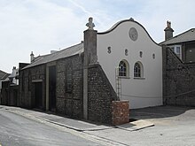 The Coach House, a "rare survival", dates from 1852. Clifton Hill Coach House, Brighton (IoE Code 493829).jpg