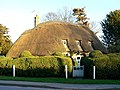Church Cottage is a 16th-century building with cob walls and thatched roof[12]
