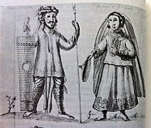 Part of the Visayan Principalia during the early Spanish colonial period, wearing richly-embroidered pre-Hispanic Visayan clothing typical of the upper classes in the 16-17th centuries. Note that the datu only wears a bahag under a long cotton tunic (baro), with clearly seen tattooed legs and face. He is accompanied by a binukot or local princess with golden bangles. Depicted in Historia de las Islas e Indios de Bisayas (1668) by Francisco Ignacio Alcina. Datu and binokot (Principalia) - Philippines (c.1668).jpg
