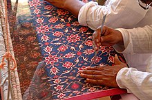 Indian textile artists demonstrate double ikat Patola weaving. Description- Textile artists demonstrate double ikat weaving at the 2002 Smithsonian Folklife Festival featuring The Silk Road. (2548928970).jpg