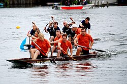 Dongola racing at the Wargrave & Shiplake Regatta on the River Thames. Note the kneeling posture and near parallel positions of the paddles. Dongola racing at Wargrave & Shiplake Regatta.jpg