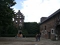 Tower ruin with the main entrance (center) and part of an outbuilding (right)