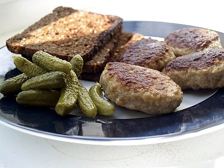 Frikadeller (meat balls) with rugbrød (rye bread) and pickled food gherkins