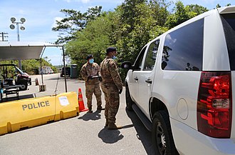 The Guam Air National Guard assisting Guam police at an isolation facility. The Guam National Guard was activated by Gov. Lou Leon Guerrero on March 21 to assist with COVID-19 efforts. Guam National Guard - 49695431352.jpg