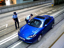 Officers of the Hong Kong Police Force stop a vehicle in a lane intended for buses and trams. HK Des Voeux Road C Bus Lane Motor Car Lost in Tram Lane n Police Uniform in Summer 2008 1 a.jpg