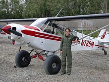 Heather Bartlett, an Arctic Refuge law enforcement officer with the Fish and Wildlife Service, next to her Piper PA-18 Super Cub in 2009 Heather Bartlett USFWS.jpg