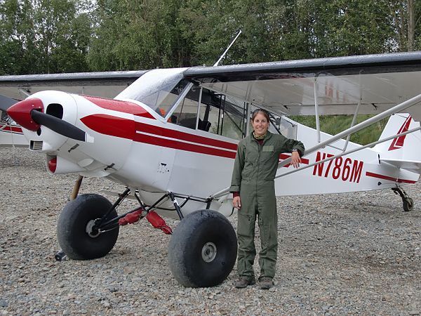 Heather Bartlett, an Arctic Refuge law enforcement officer with the Fish and Wildlife Service, next to her Piper PA-18 Super Cub in 2009