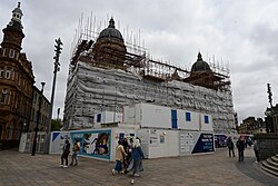 The Hull Maritime Museum in Queen Victoria Square, Kingston upon Hull, under extensive renovation in June 2023. Recent works have finally revealed the roof of the building after about a year spent underneath scaffolding and tarpaulin.