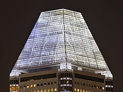 Illuminated roof of the skyscraper Millenia Tower at night in Singapore