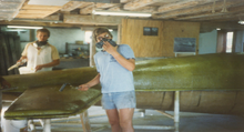 Dale (left) and Alan spreading resin over the VK-30's fiberglass mold in the basement of their barn, about 1985 Klapmeier brothers painting fuselage of VK-30.png