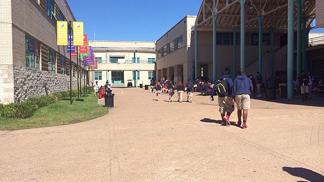 Courtyard of Lamar High School. Lamar students wearing school uniforms are visible in this picture.