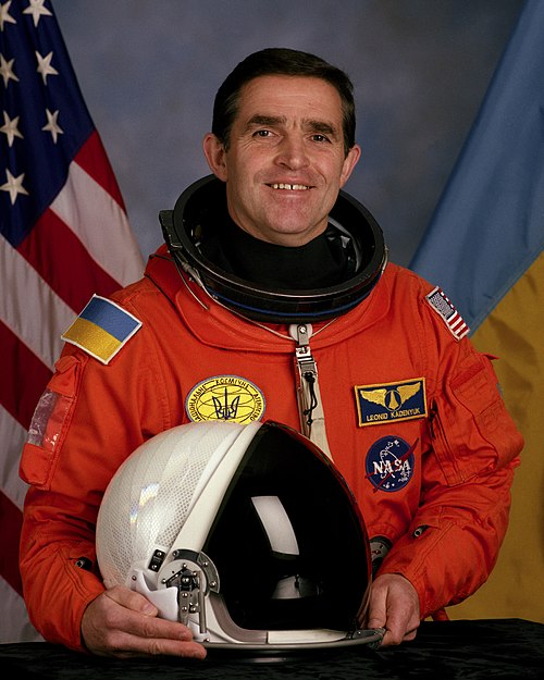 Ukrainian astronaut Leonid Kadenyuk seen with a badge of payload specialist on the left side of his chest