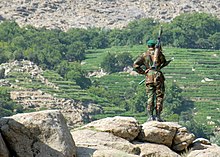 An Afghan soldier surveying a valley during an anti-Taliban operation Operation Nowruz Jhala DVIDS54117.jpg