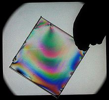 Photoelastic experiment showing the internal stress distribution inside the cover of a Jewel case Photoelasticimetry1.JPG