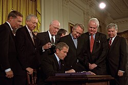 President George W. Bush signing the USA PATRIOT Act, in the White House's East Room on October 26, 2001. President George W. Bush Signs Patriot Act.jpg